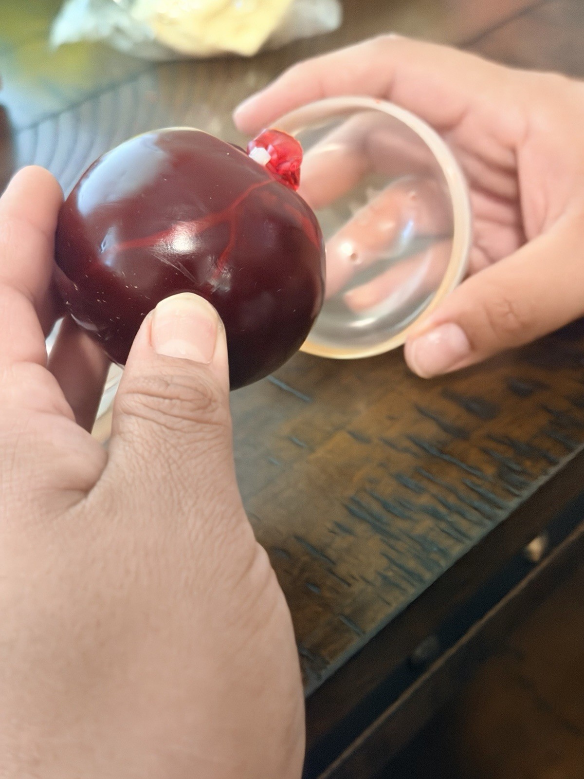 Red squeeze wax squeeze ball in Clear Plastic Display Case